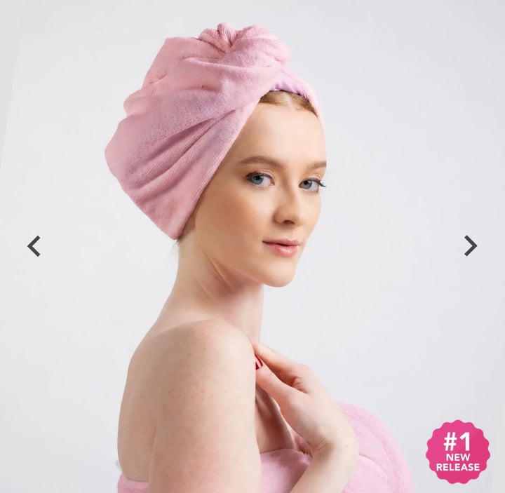 Model wearing a pink Hairbrella towel turban with the microfiber side facing outward and the towel twisted at the crown.
