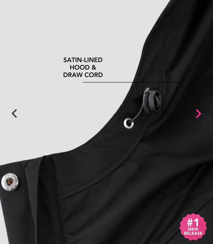 Close-up of the black Hairbrella jacket hood, showing its drawcord toggle, satin lining and a snap at the neckline.