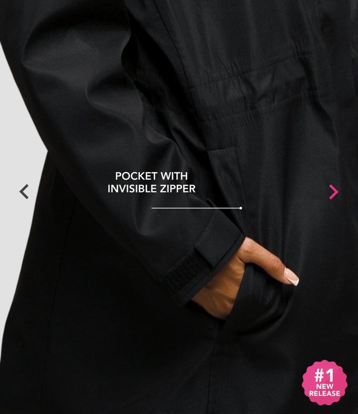 Close-up of a hand in the black Hairbrella jacket pocket, with a callout identifying its concealed zipper.