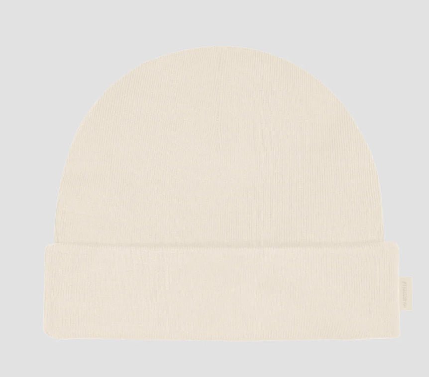 Light cream Hairbrella kids cuffed beanie with a folded brim and small side label.