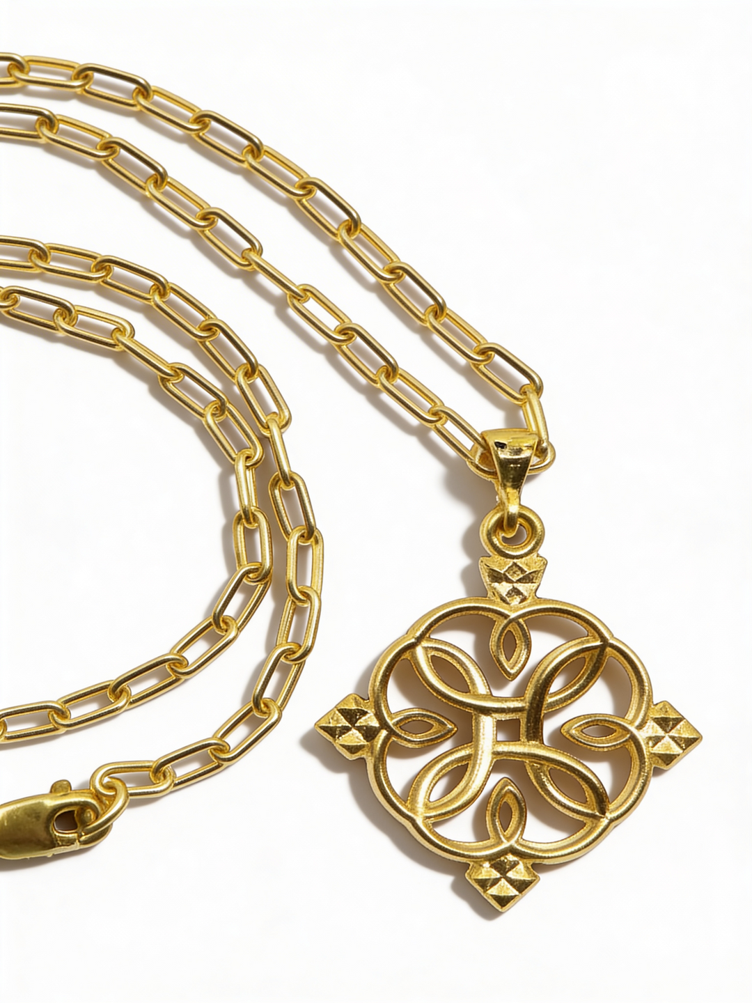 Gold-tone Liya 1.0 circular cross pendant with its chain and clasp arranged on a white background